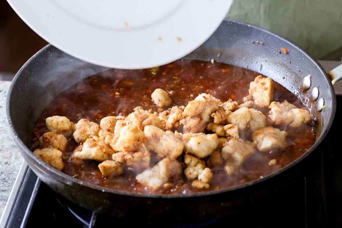 adding tofu to the thickened Indo-Chinese garlic pepper sauce