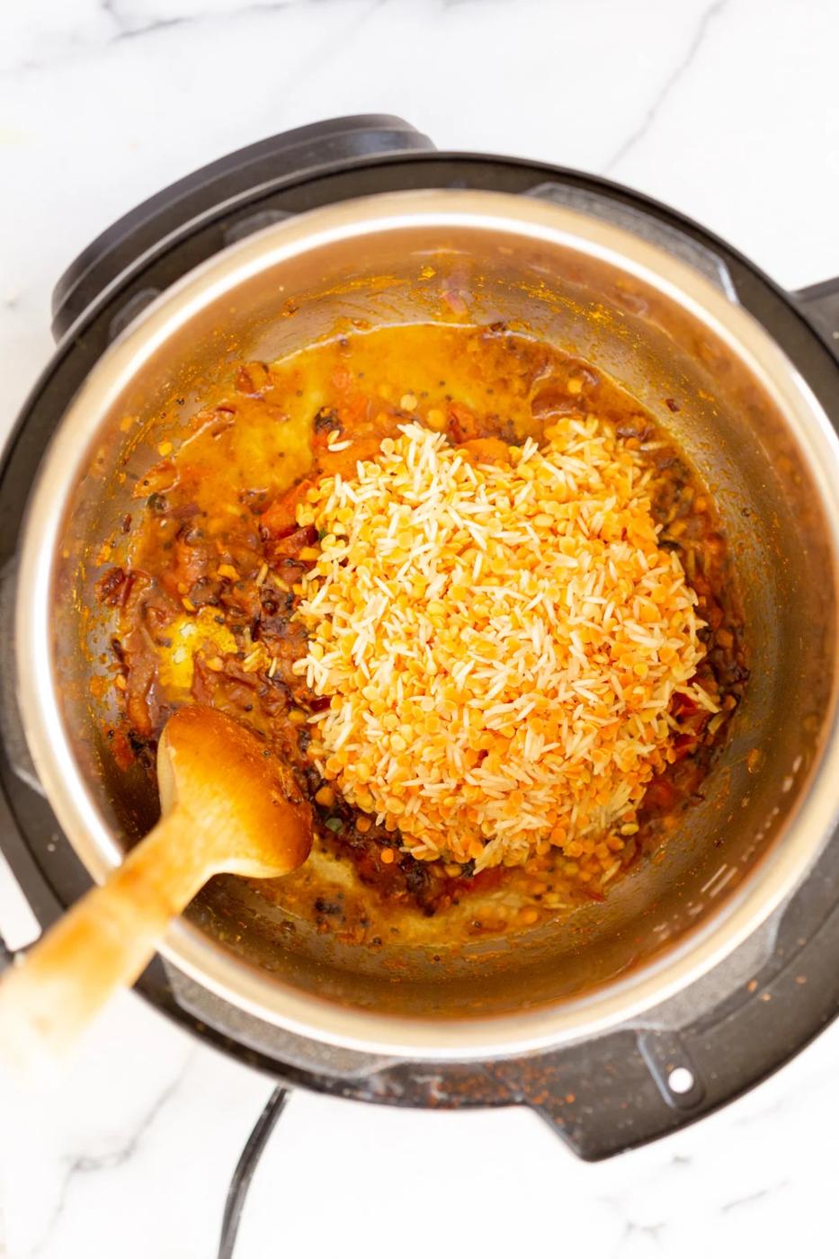 soaked rice and lentils being added to Instant Pot to make Kitchari