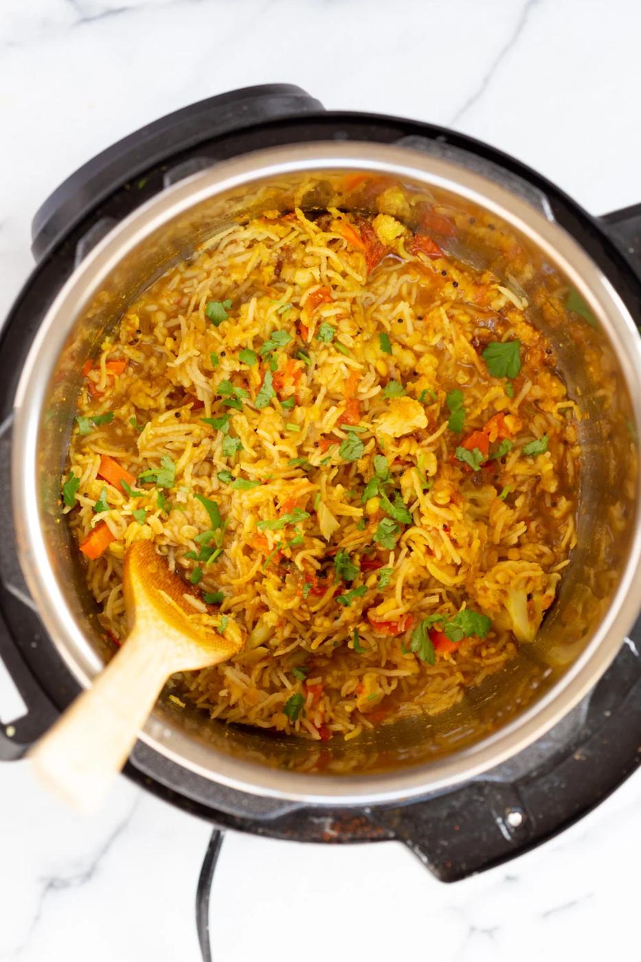 fresh cilantro being sprinkled on top of kitchari