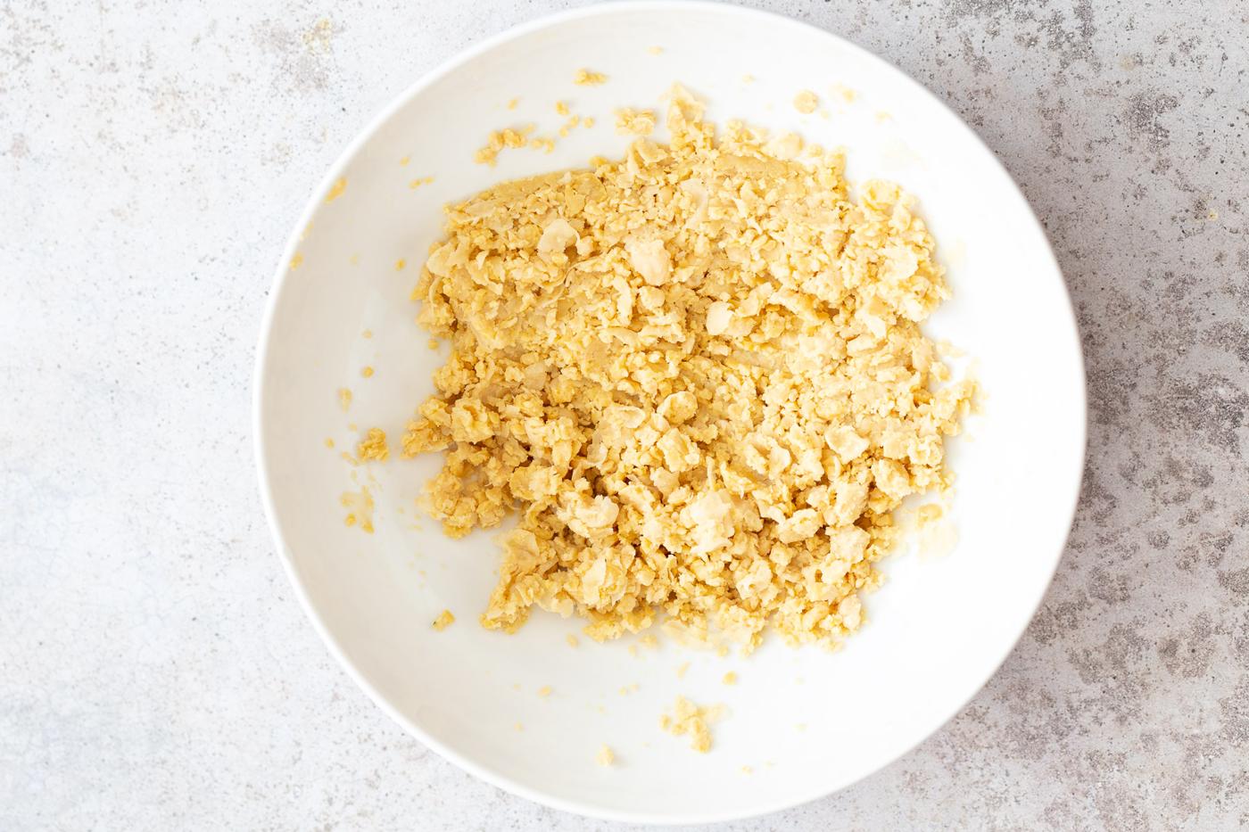 mashed chickpeas in a white bowl