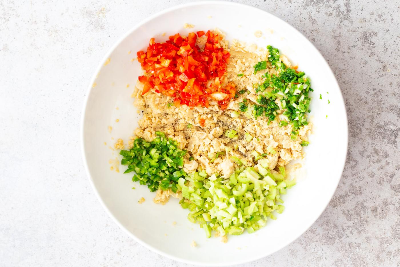 vegan chickpea salad ingredients assembled in a white bowl