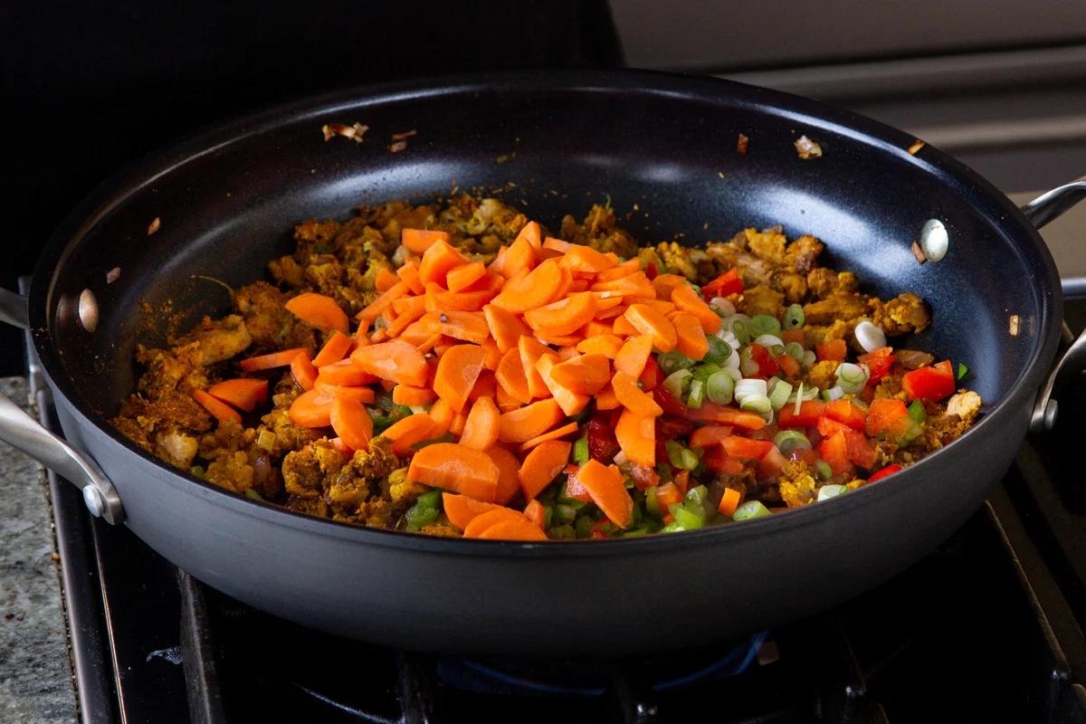 adding the carrots to the pan