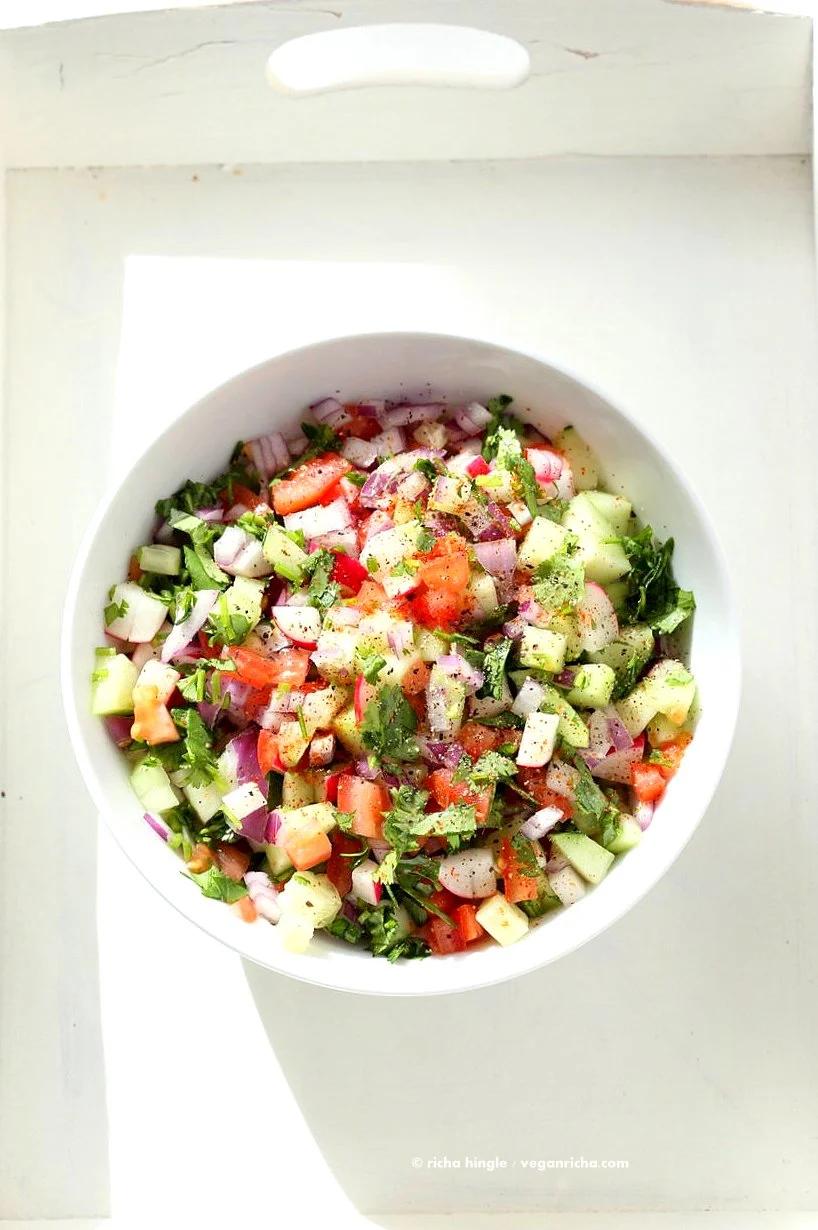 Kachumber Salad - Cucumber Tomato Onion Salad Recipe. Kachumbar is a simple chopped Summer Salad with chopped onions, tomatoes, cucumbers and a salt pepper lemon dressing. Serve as a side with Indian curries, or as a dip with chips, or over burgers. Vegan Gluten-free Soy-free Oil-free Recipe | VeganRicha.com
