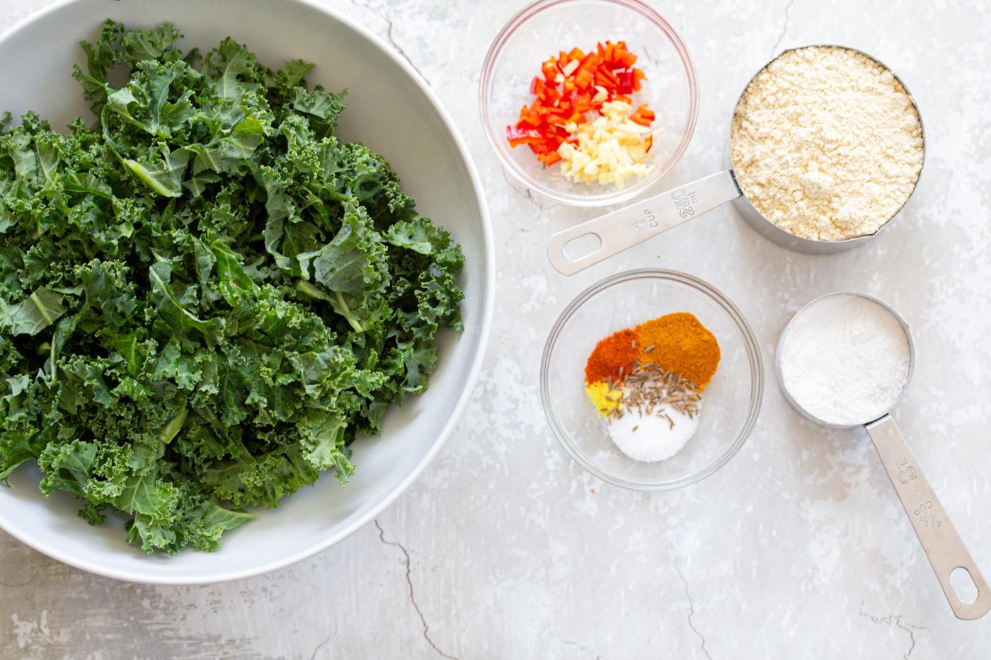 Ingredients laid out for Kale Pakora in bowls