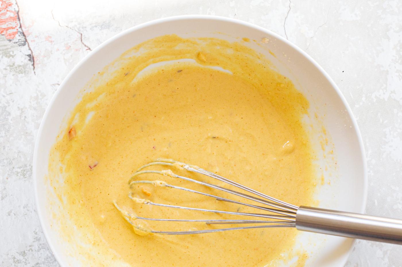 Batter for our Kale Pakora in a white bowl