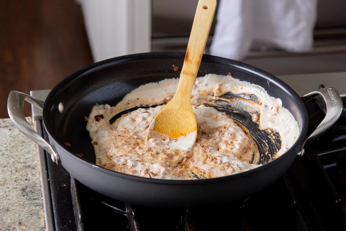 vegan cream in the pan mixed with spices and onions
