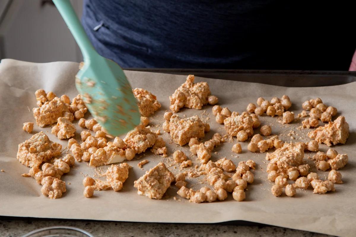 sauced chickpeas and tofu on the baking sheet before baking