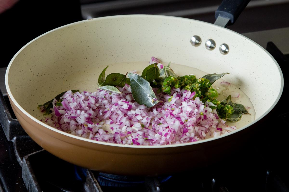 adding onion, shallot, chili, and curry leaves to the pan