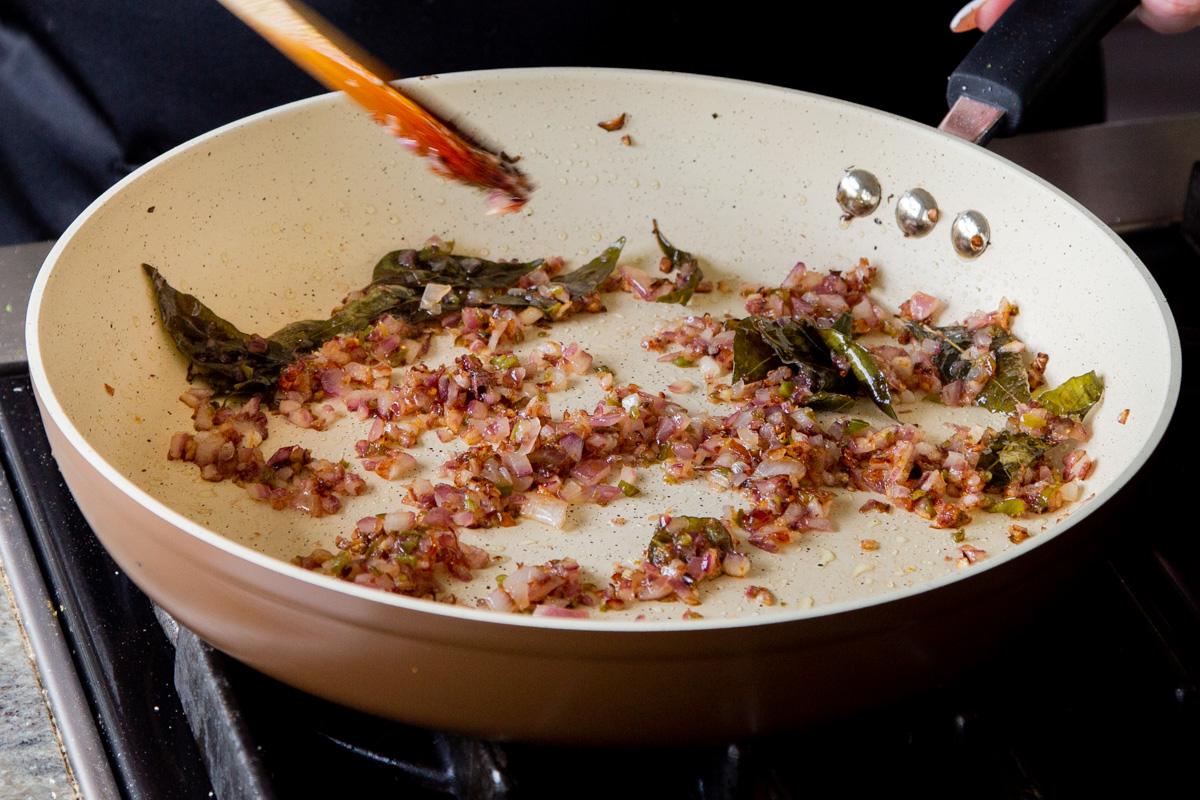 onion, shallot, chili, and curry leaves in the pan after cooking