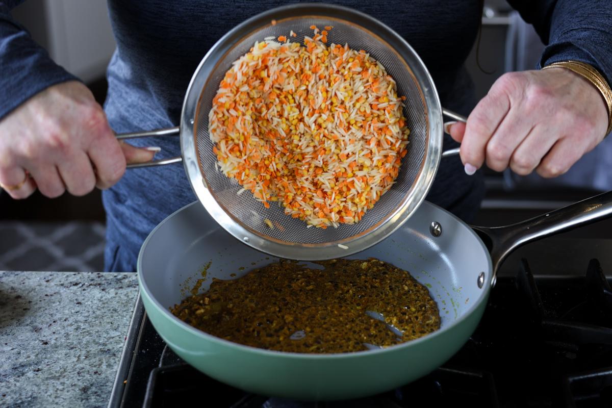 adding lentils and rice to the pan