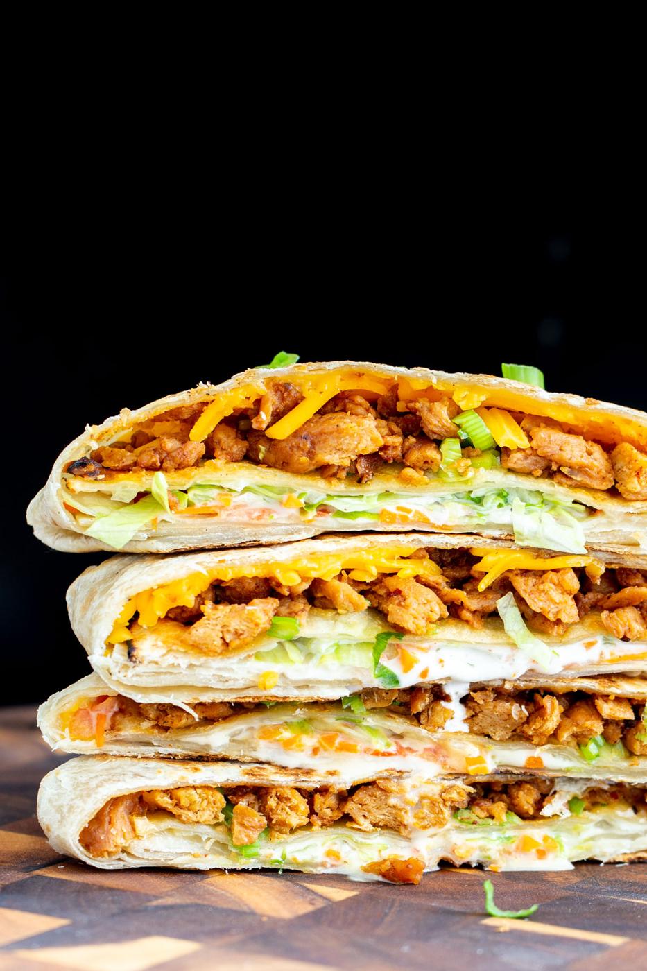 a stack of halved vegan crunchwraps filled with Korean BBQ soycurls, vegan cheese, veggies and Ranch