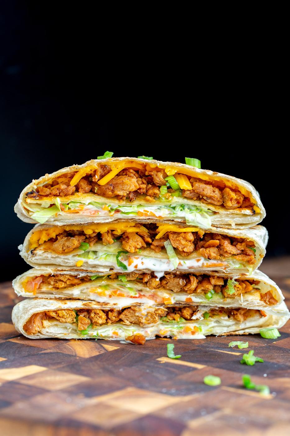 vegan Korean bbq crunchwrap stacked on a wooden board