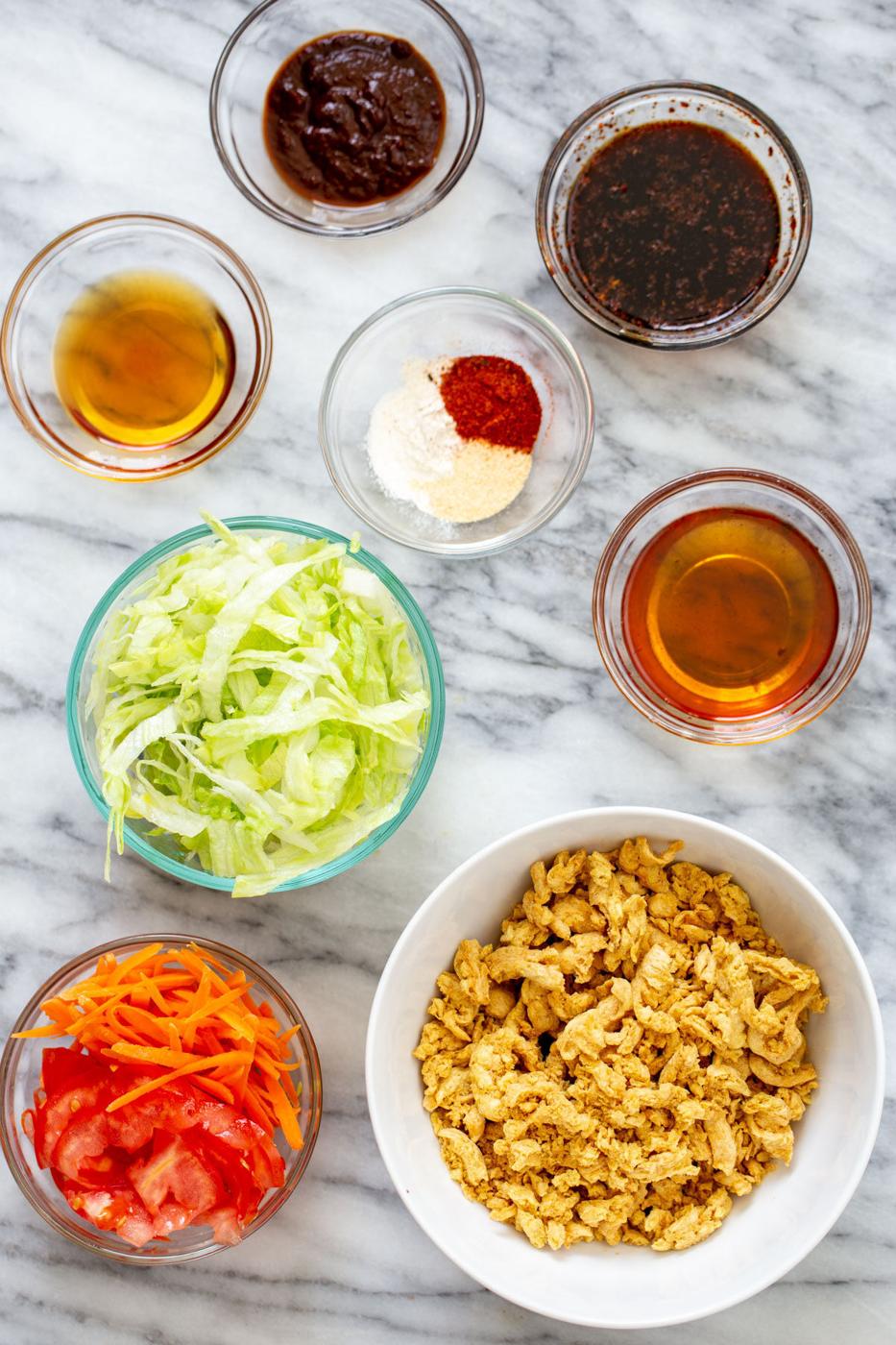 ingredients for making vegan crunchwraps on a marble countertop