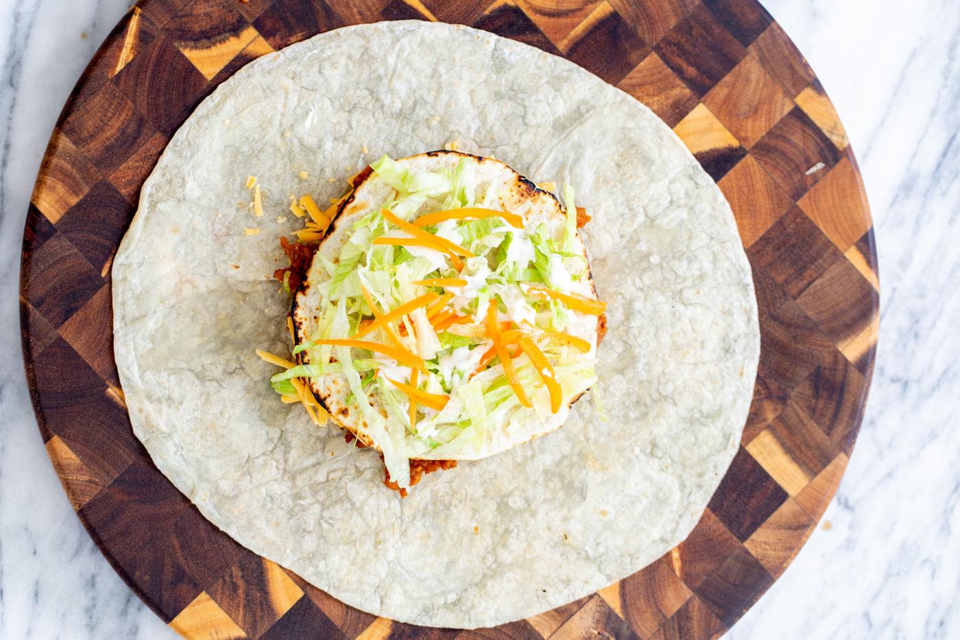 vegan crunchwrap with toppings ready to be folded and toasted