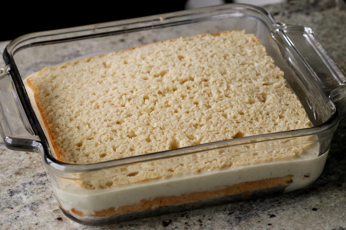 adding the second cake layer to the pan