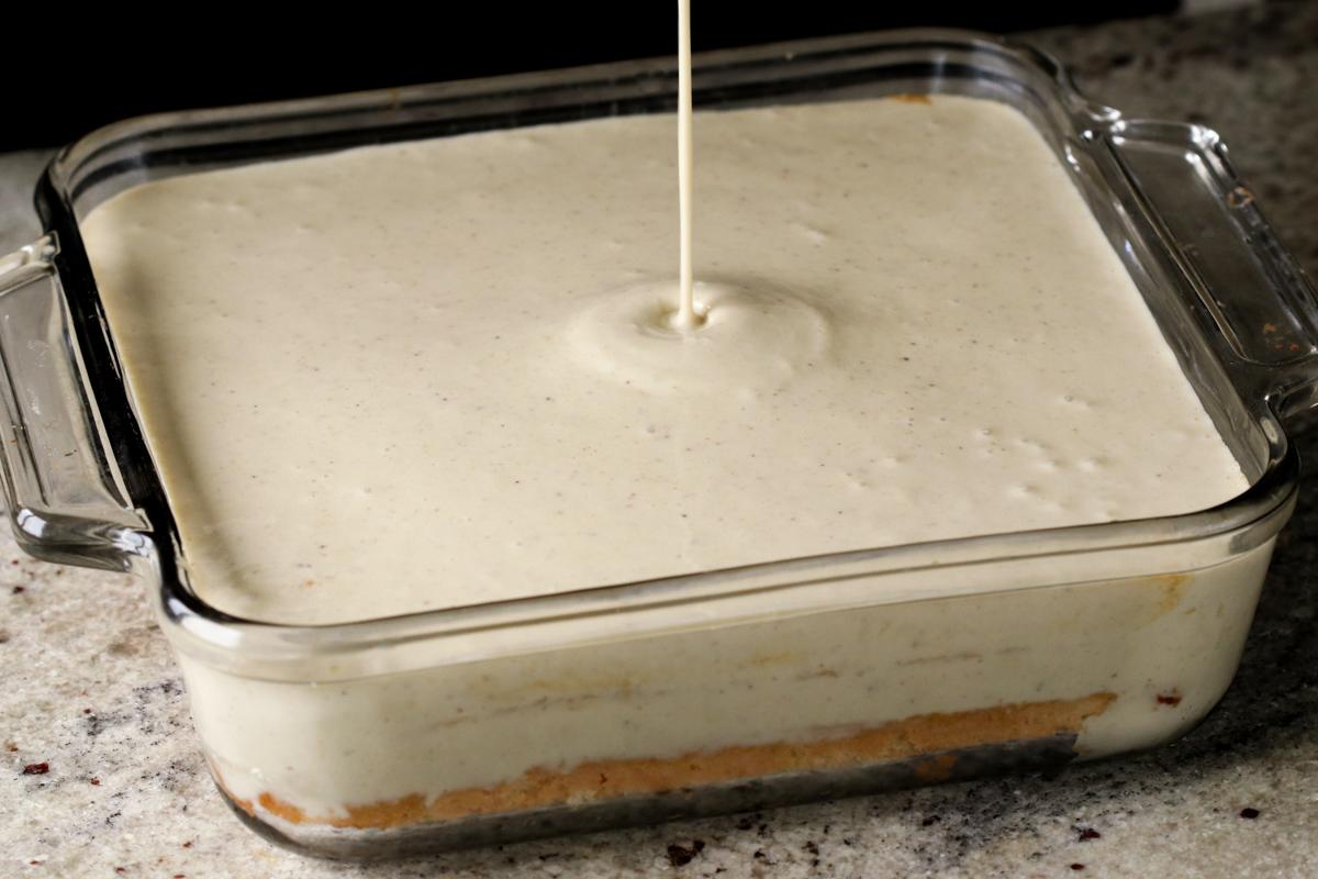 adding the second kulfi cream layer to the pan