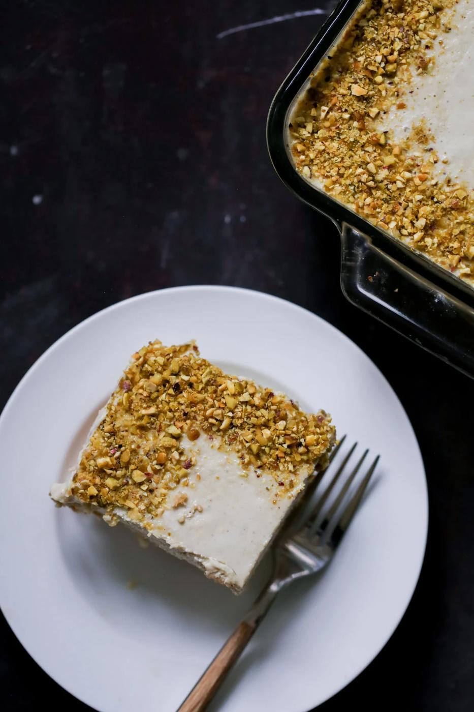 overhead photo of a slice of Indian tiramisu on a white plate with a fork