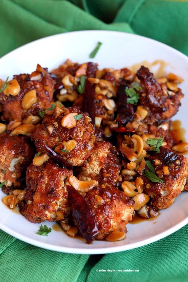 Crispy Kung Pao Cauliflower. Cauliflower battered and baked and tossed in spicy kung pao sauce. | VeganRicha.com #vegan #appetizer #snack #cauliflower #kungpao #recipe
