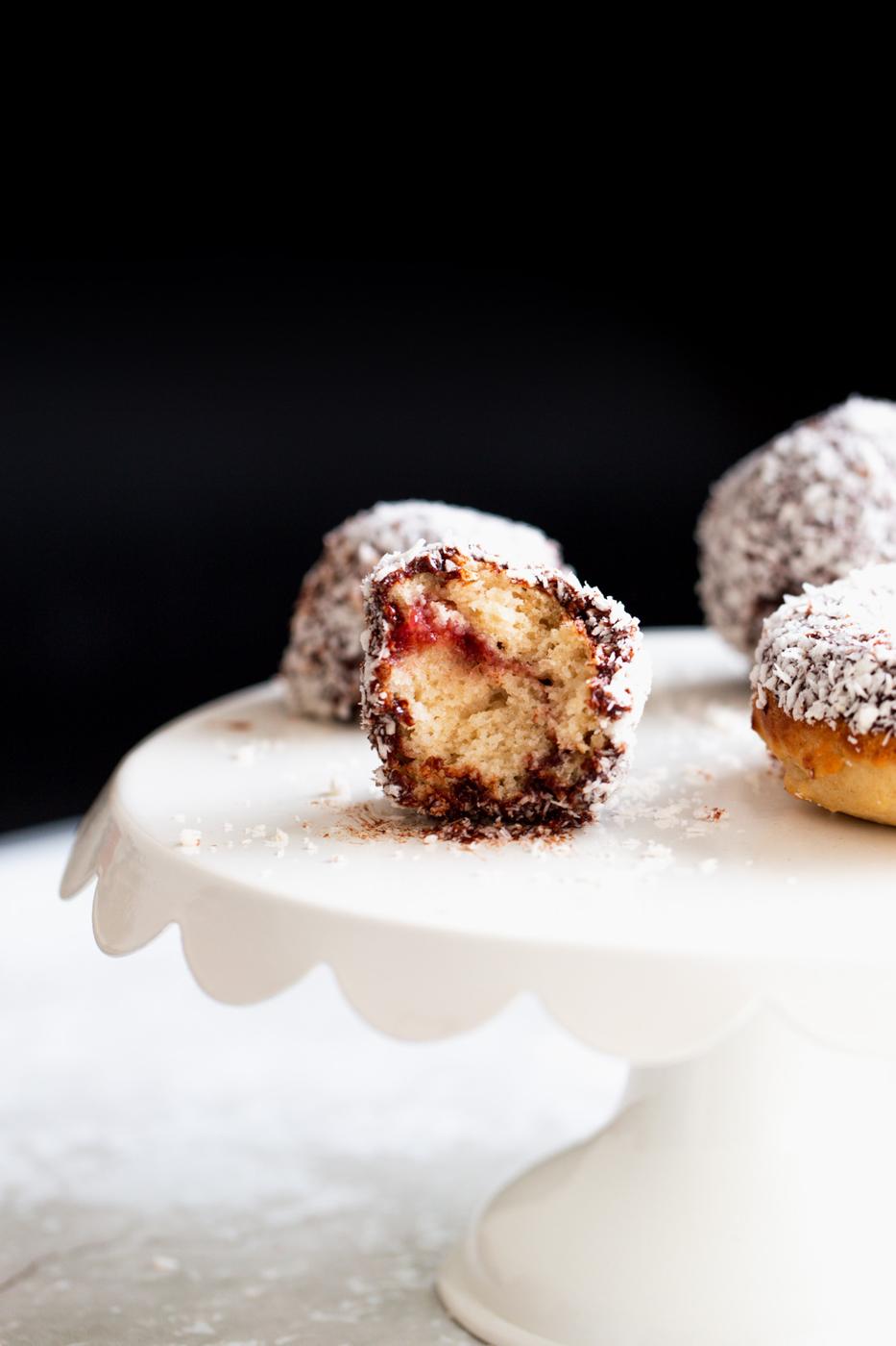 half a vegan lamington donut hole with one bite taken