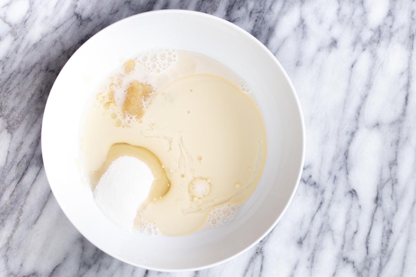 wet ingredients for vegan donuts being mixed in a bowl