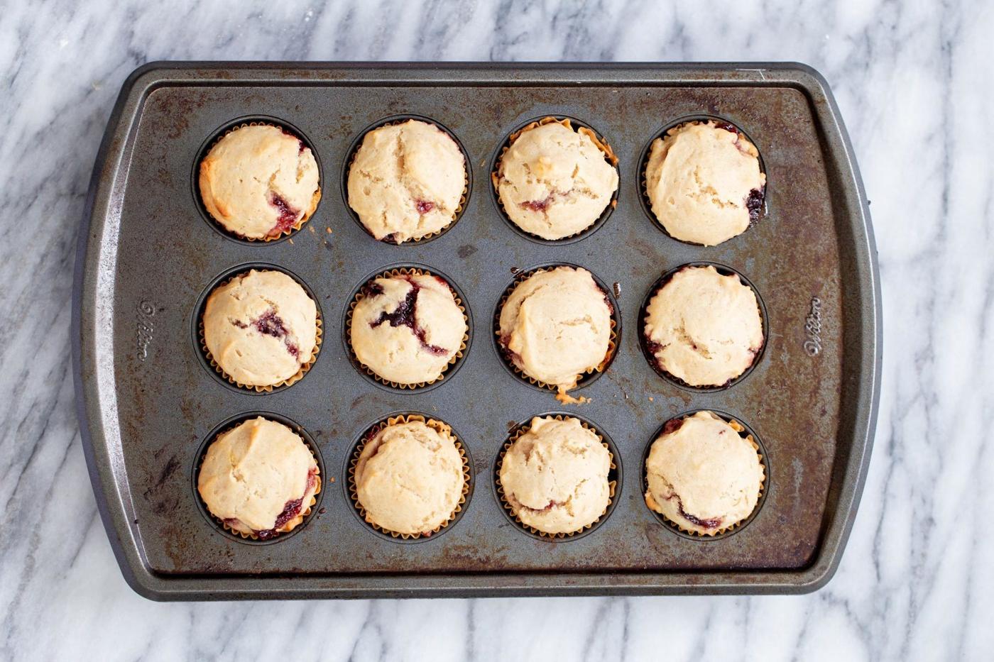 freshly baked lamington donut holes in a muffin pan