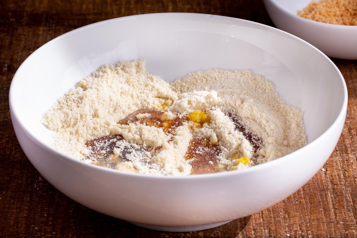 maple syrup and lemon zest being added to a bowl