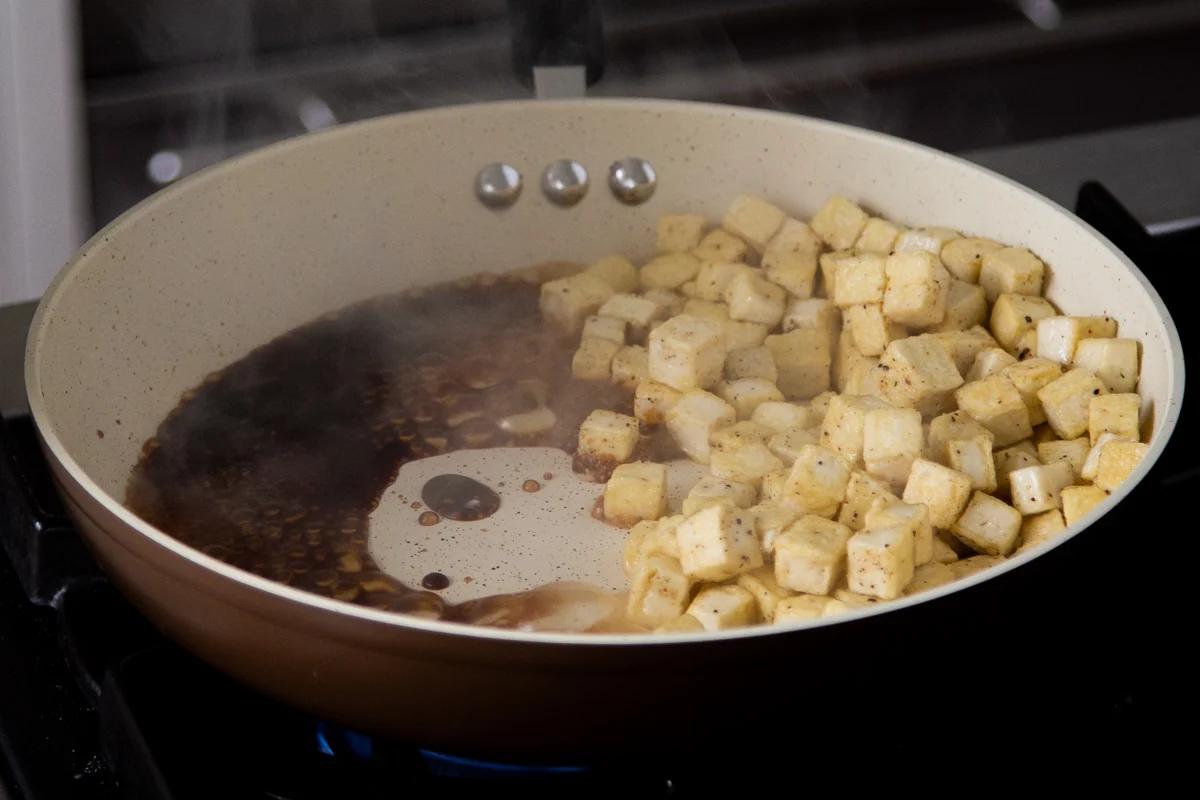 tofu moved to the side of the pan with the sauce ingredients added