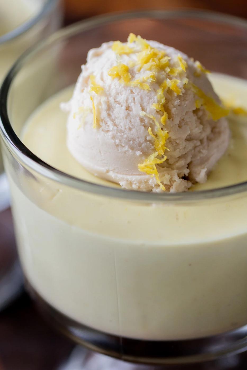 close-up of a cup of vegan lemon pudding topped with vanilla ice cream