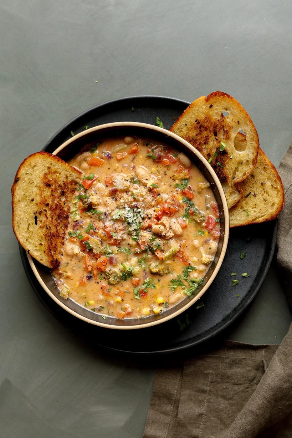 lemon white bean soup in a bowl with garlic bread