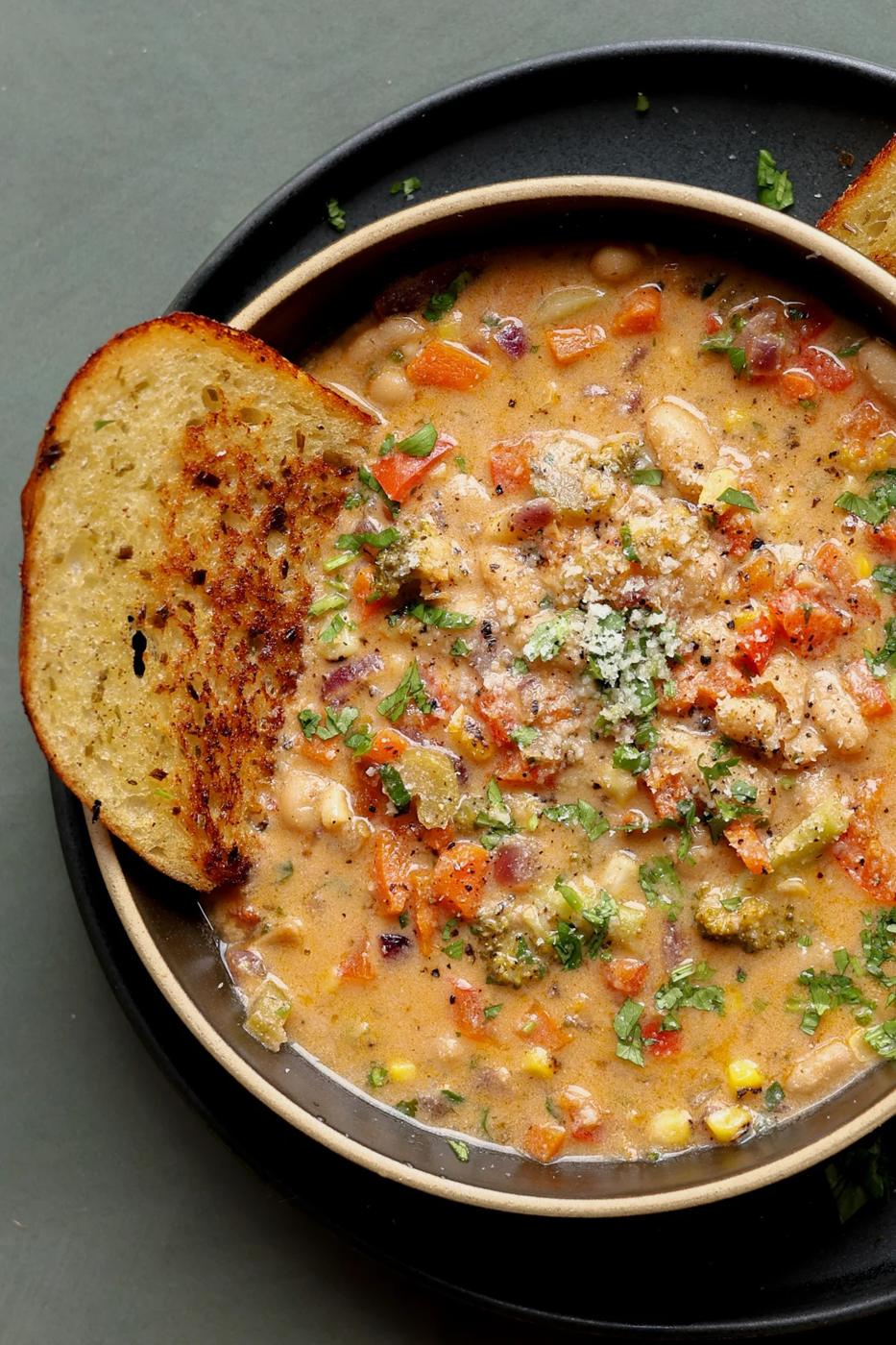 lemon white bean soup in a bowl with garlic bread