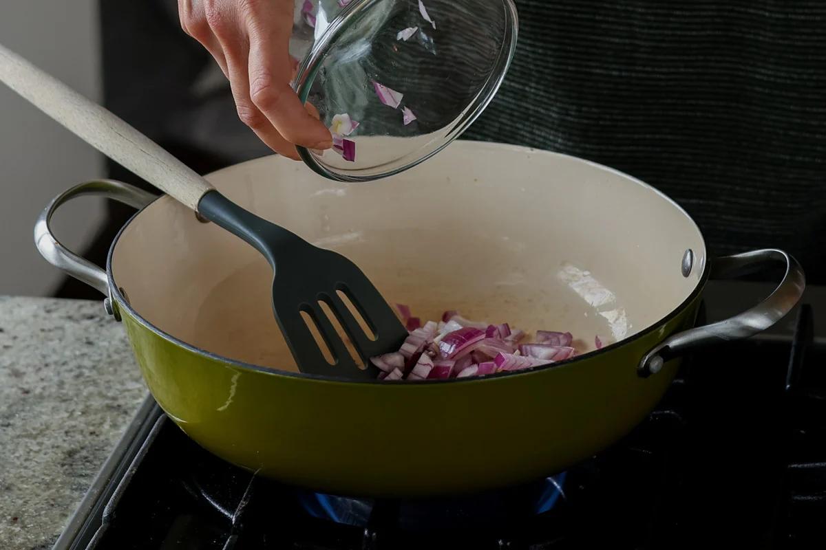 adding onions to the pan