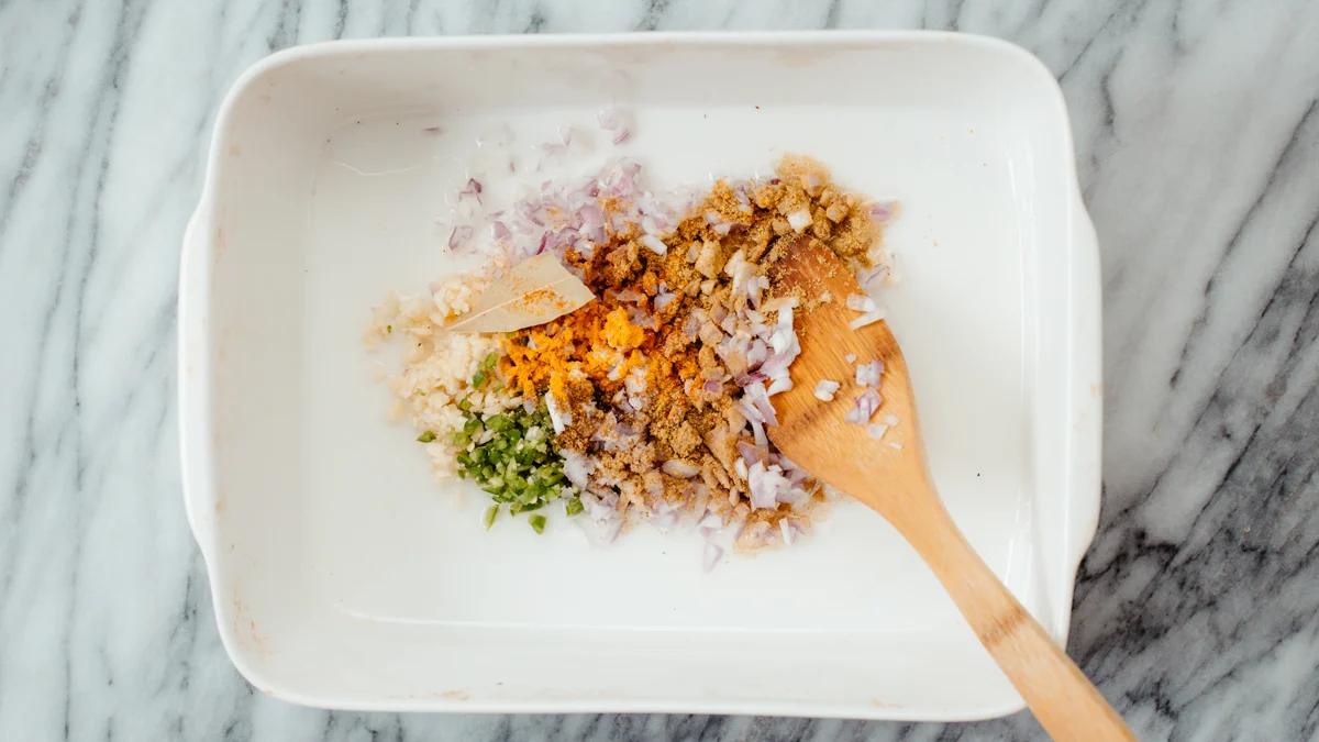onion, ginger, chili and spices in a casserole dish