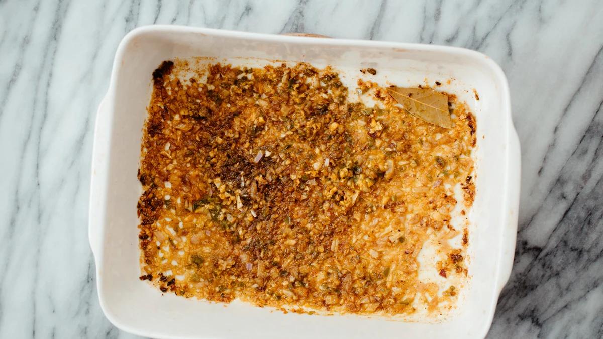 overhead shot of a casserole dish with roasted spices, onions and garlic