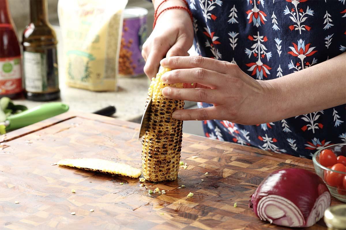 slicing the corn off the cob