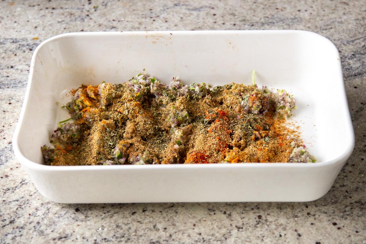 ground spices added to the chopped aromatics in the pan before baking
