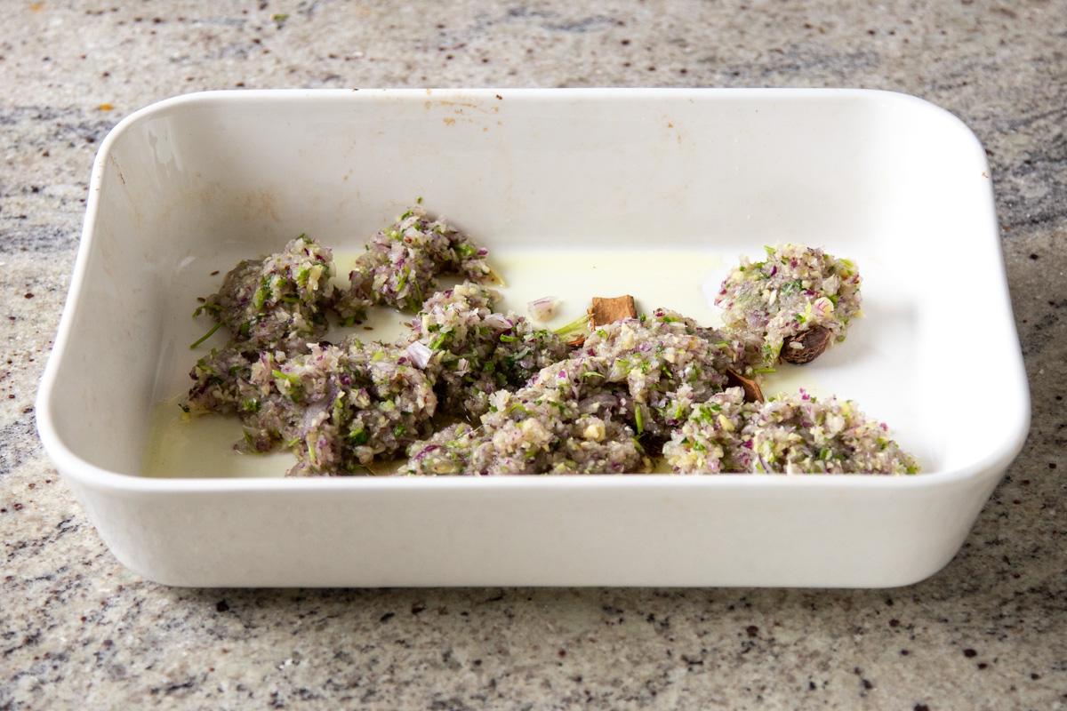 chopped aromatics added to the baking pan