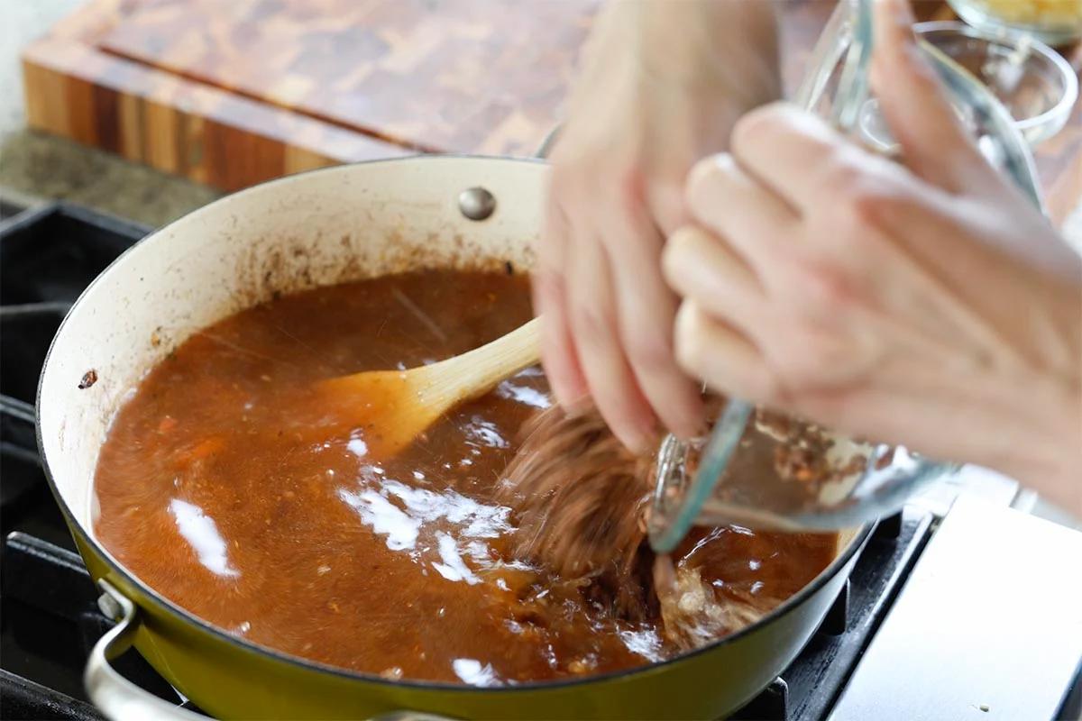 adding lentils to the pan