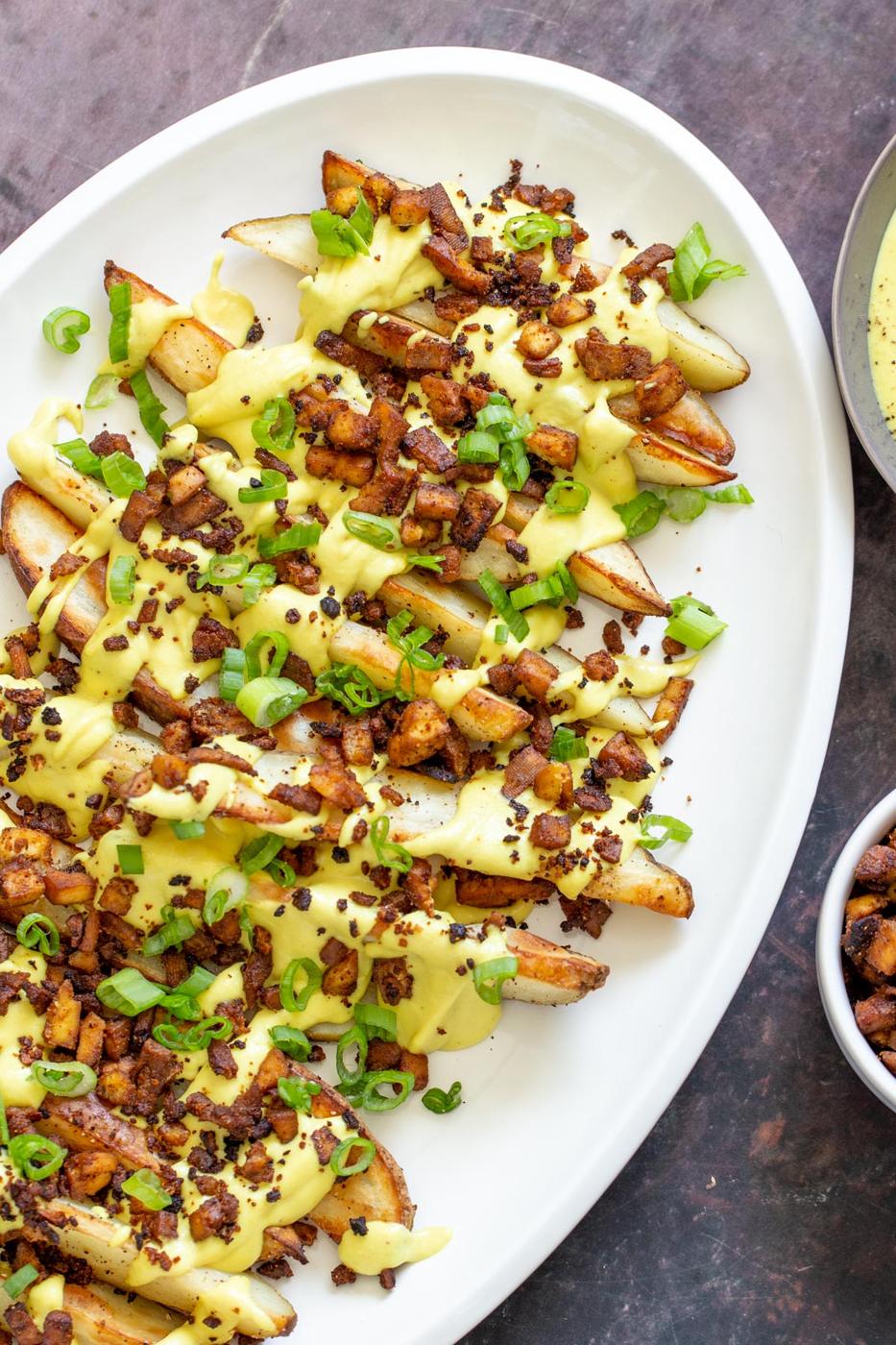 loaded potato wedges drizzled with vegan cheese sauce