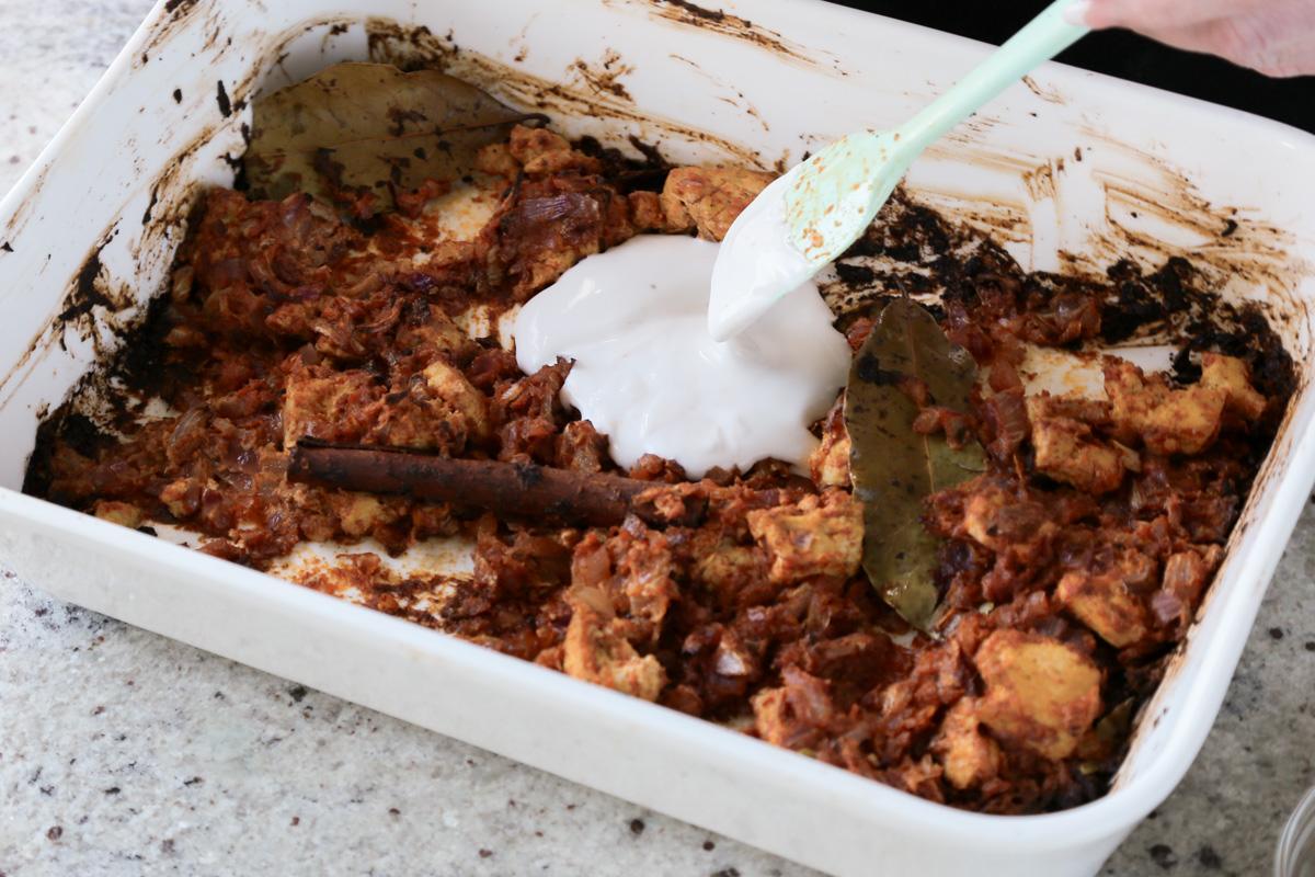 adding more non-dairy yogurt to the baked tofu and onions