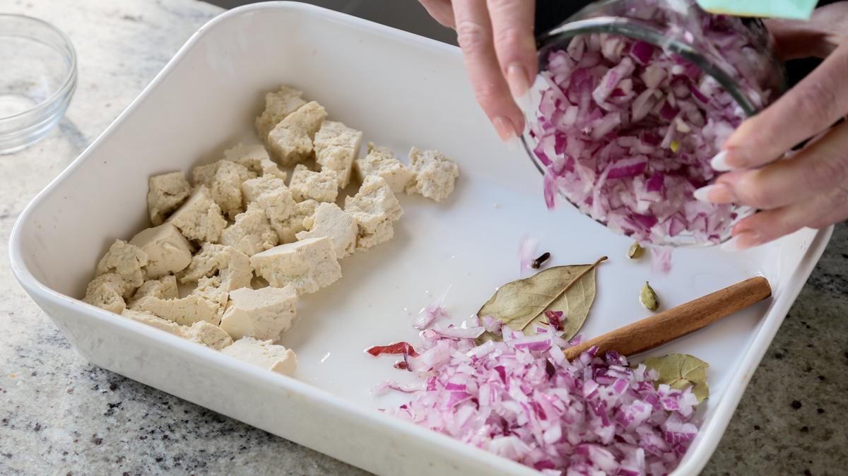 adding onion to the other side of the baking pan