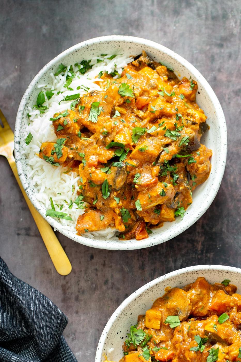 a serving of rich Indian Madras Curry tofu casserole served with rice and fresh cilantro