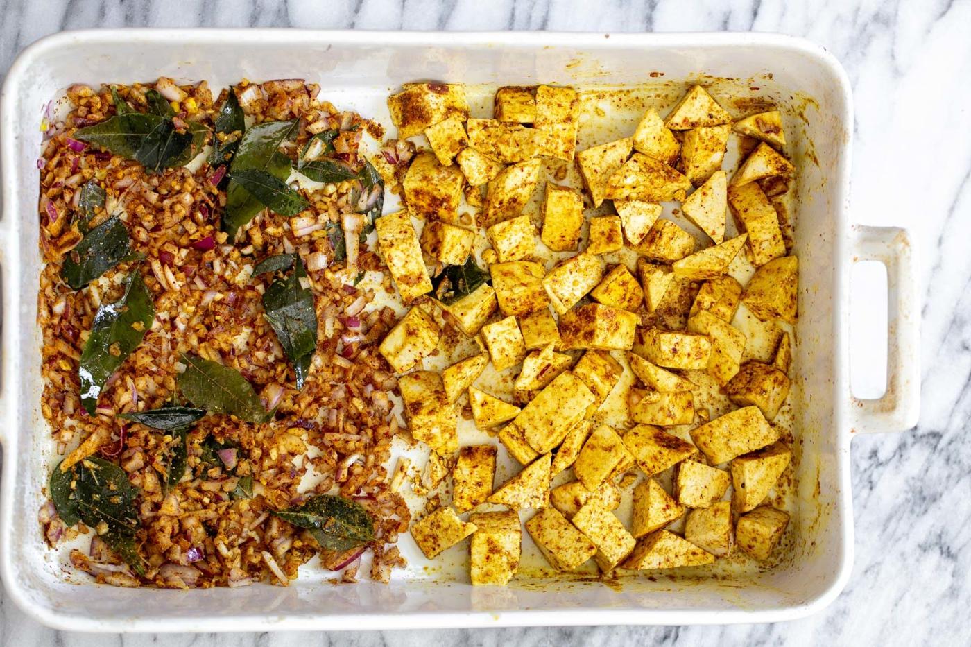 casserole dish with curry spiced baked tofu and onions