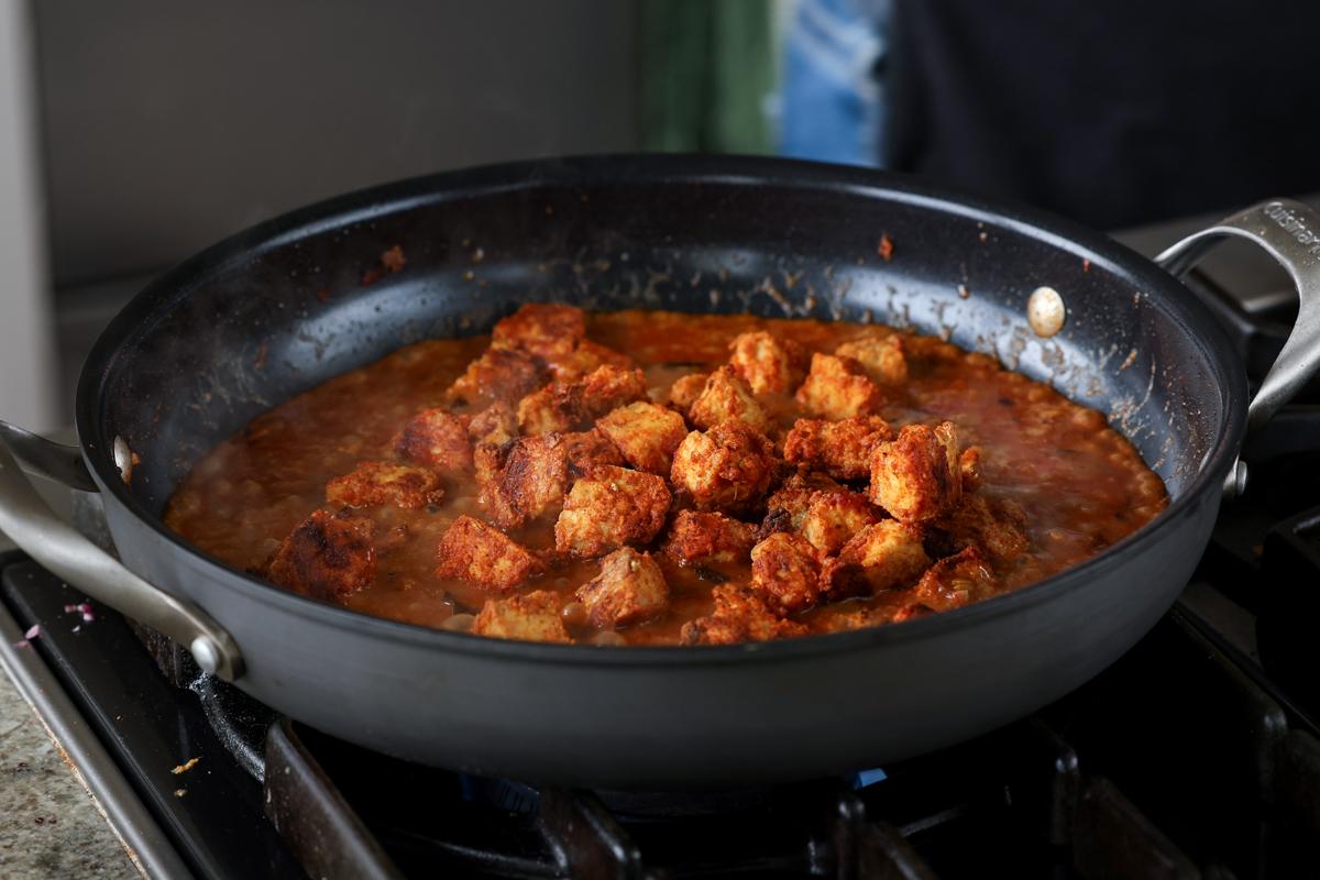 tofu "chicken" in the pan of curry sauce