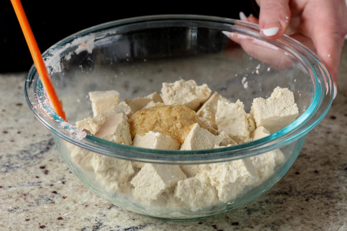 adding ginger garlic paste to the tofu