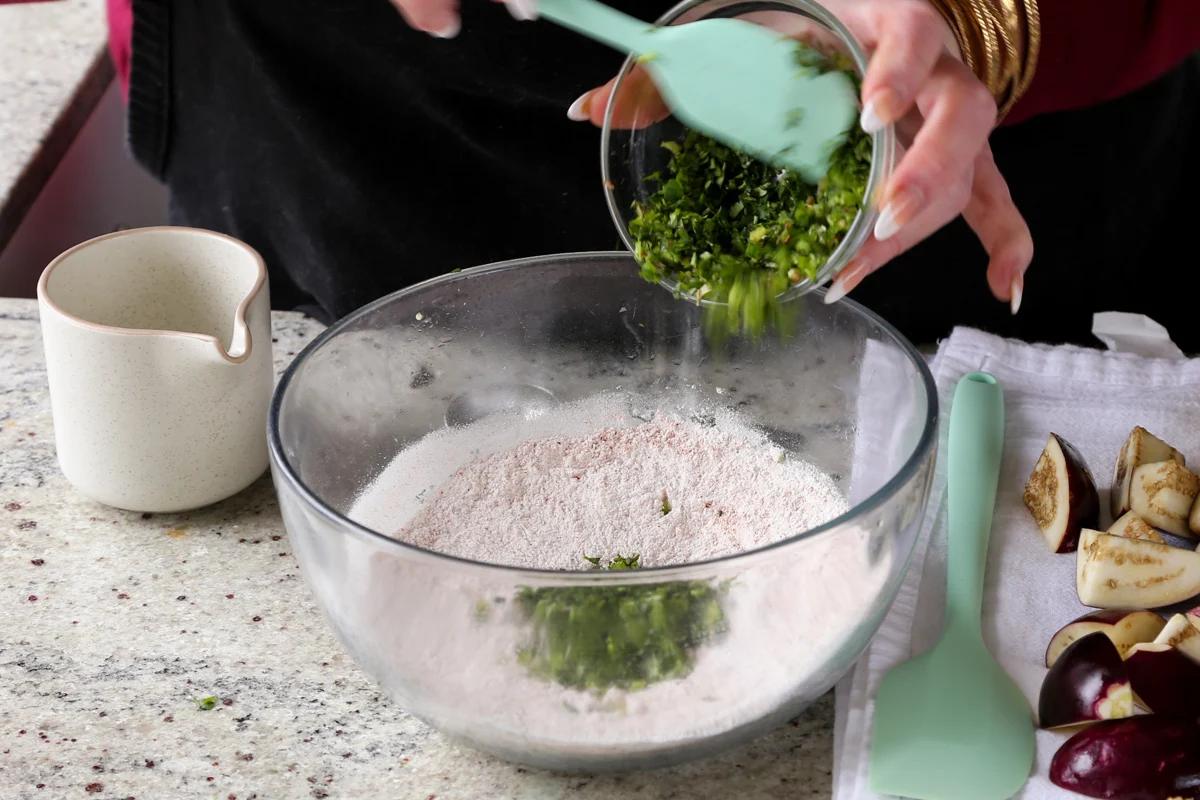 adding rice flour and cilantro and chili to the batter