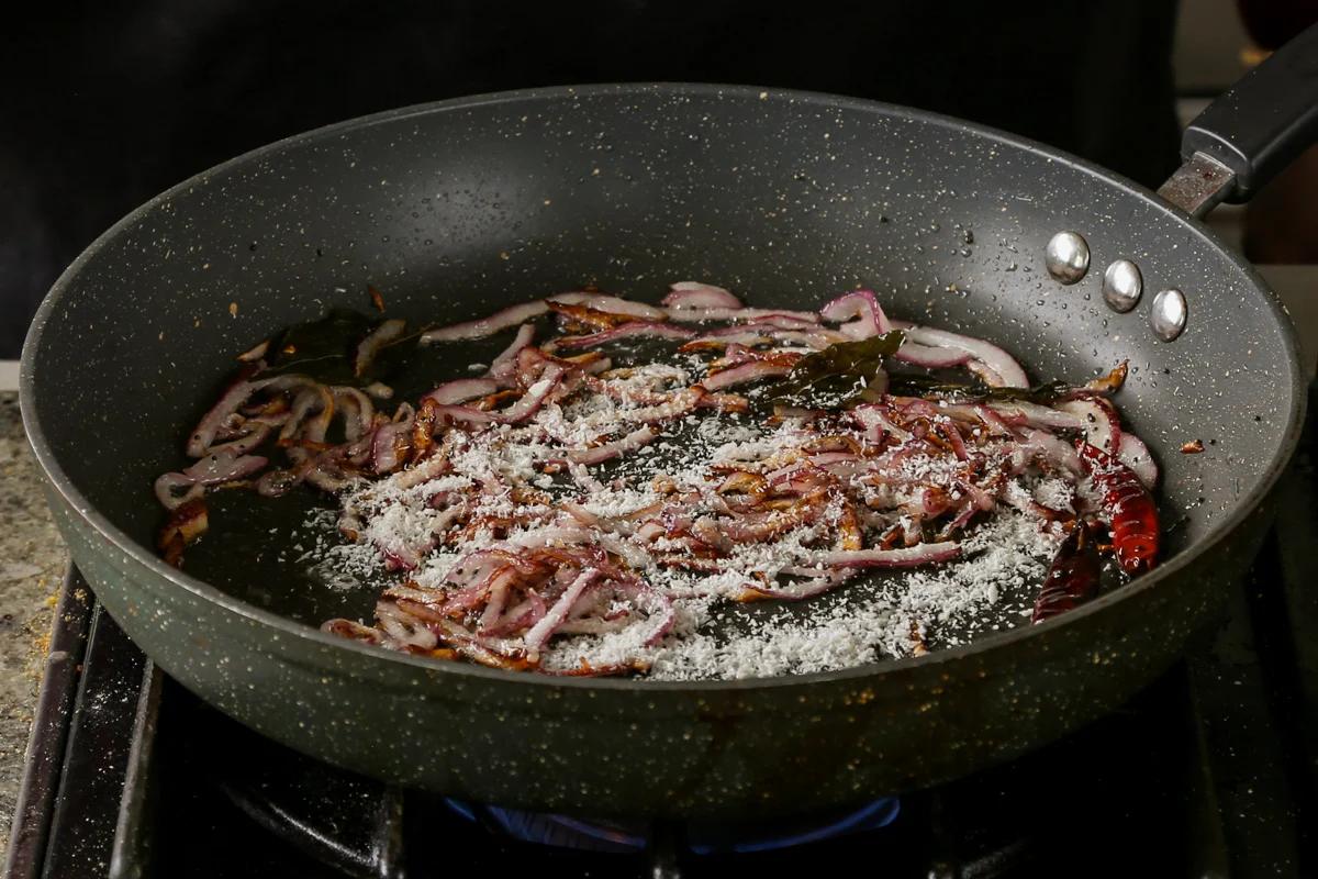 adding coconut to the pan