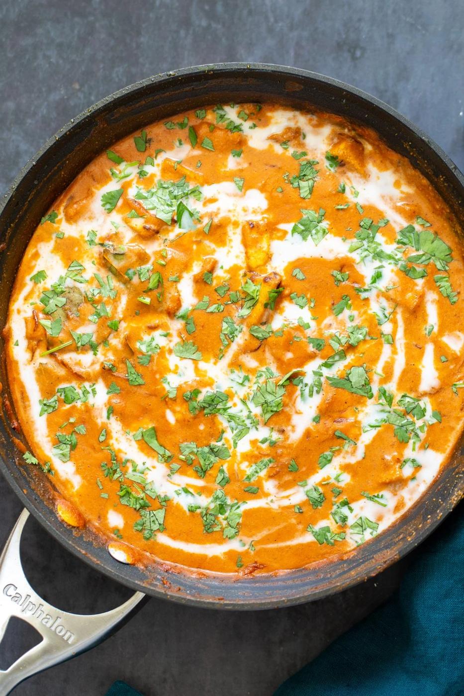 Indian malai tofu curry with coconut cream in a sauteeing pan