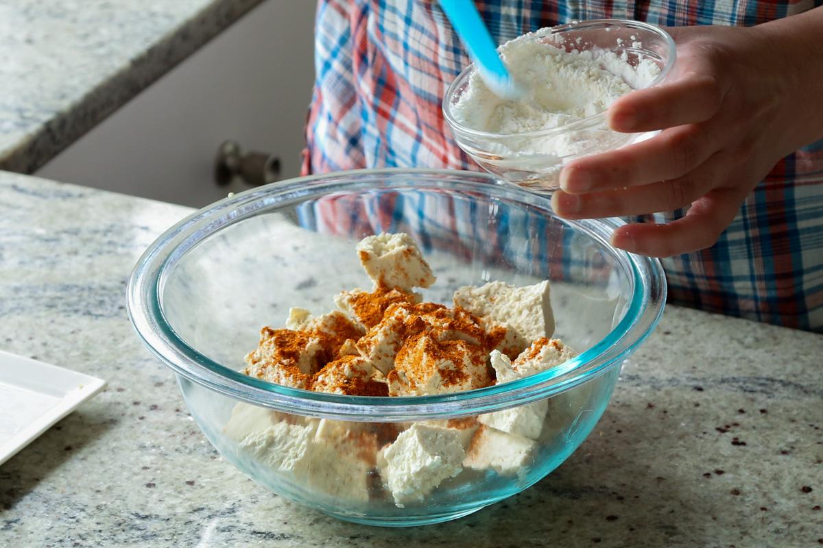 adding cornstarch to the tofu
