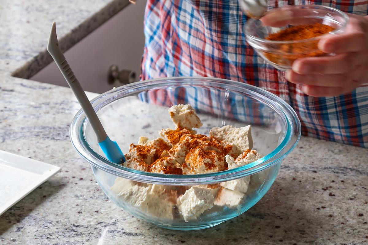 adding spice mixture to the tofu