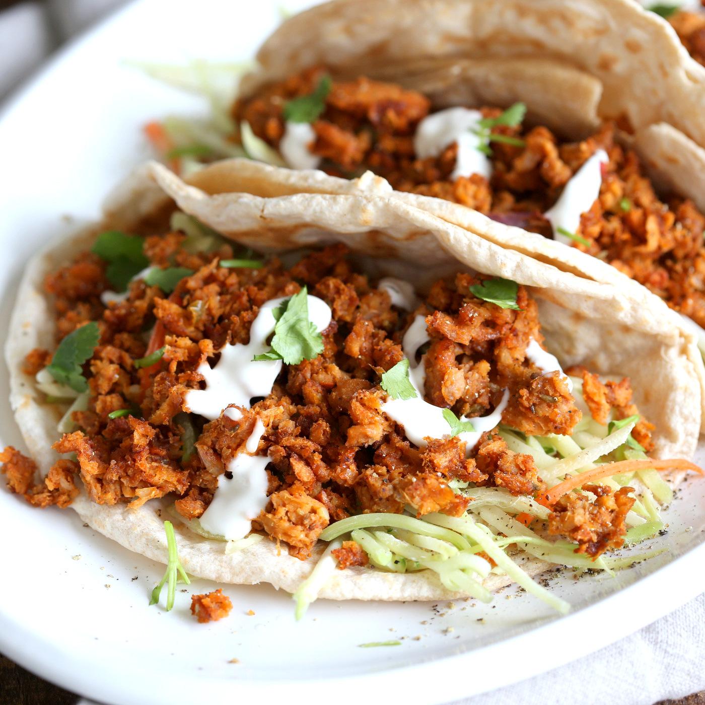 Mango BBQ Soy Curls or Jackfruit Tacos. Shredded Soy Curls or Jackfruit make a an amazing carrier for bbq sauce. Some Mango or other fruit puree takes it to the next level. Serve in sandwiches or tacos with slaw. #Vegan #Glutenfree #Recipe #veganricha | VeganRicha.com